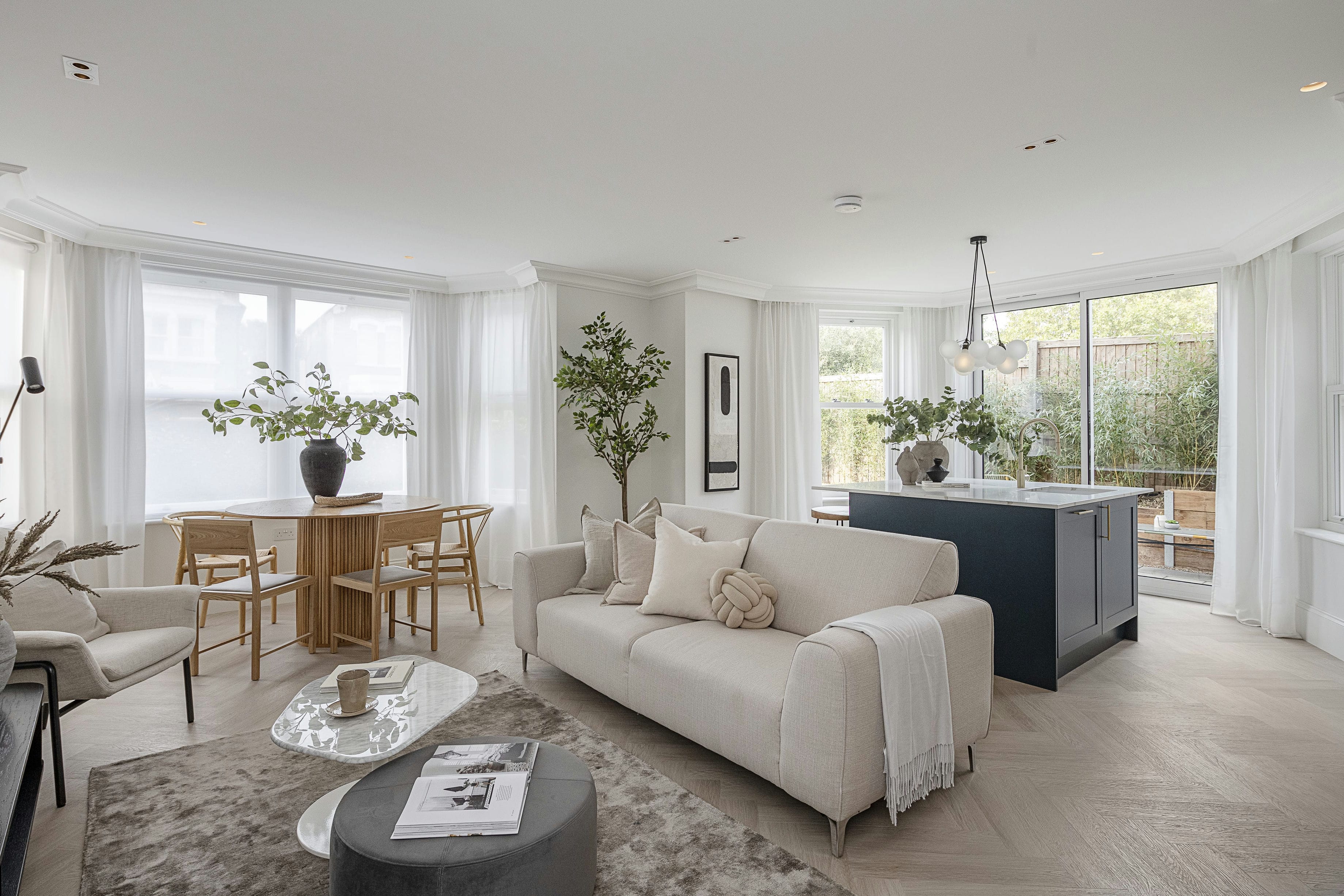 The Rosemont apartment open-plan living, dining and kitchen with bay windows &mdash; styled by Ademchic
